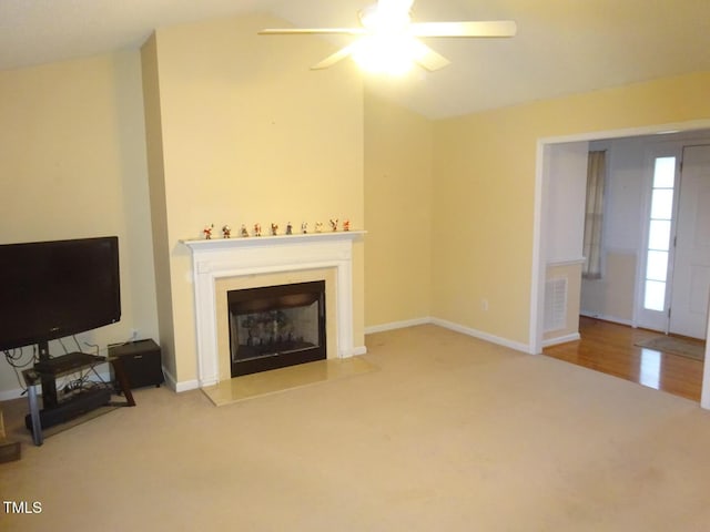 living room with ceiling fan and light colored carpet