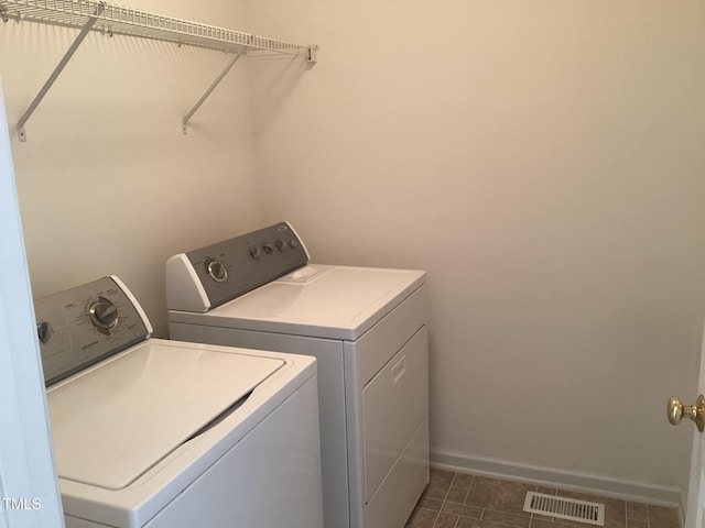 clothes washing area with washing machine and dryer