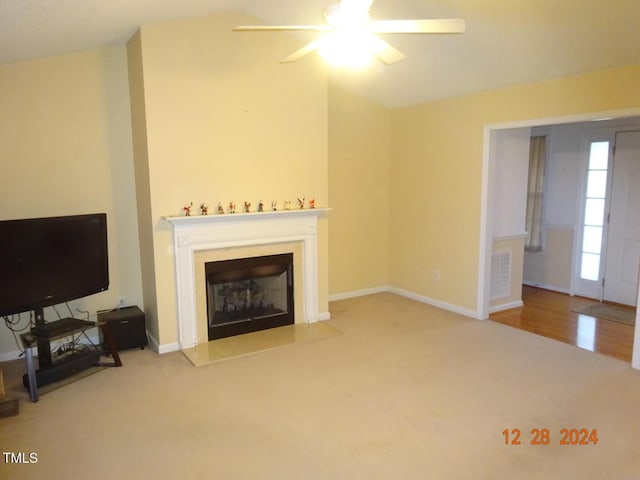 carpeted living room featuring ceiling fan