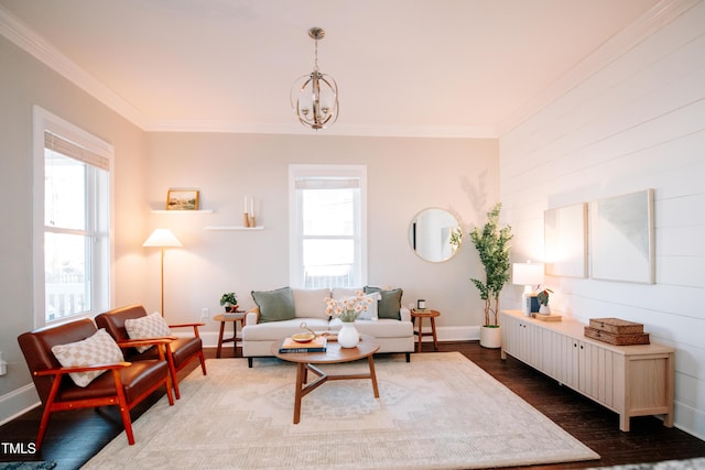 living room with dark hardwood / wood-style flooring, an inviting chandelier, and ornamental molding