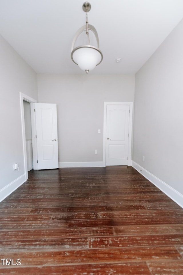 spare room featuring dark wood-type flooring