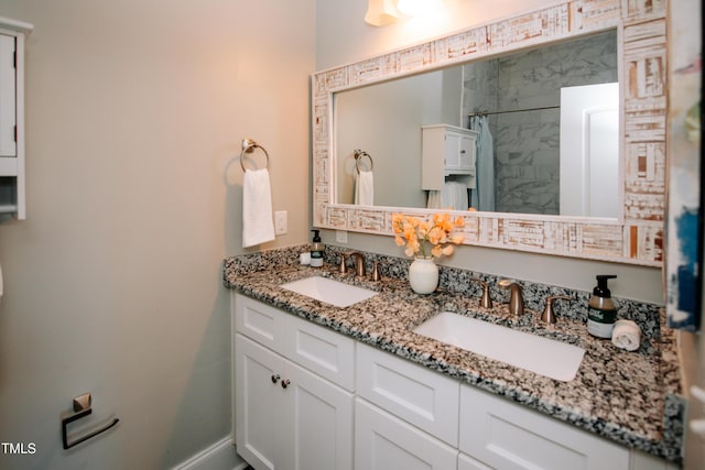 bathroom with a tile shower and vanity