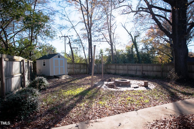 view of yard featuring a fire pit and a storage unit