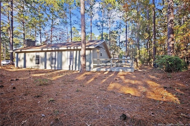 back of house featuring a deck