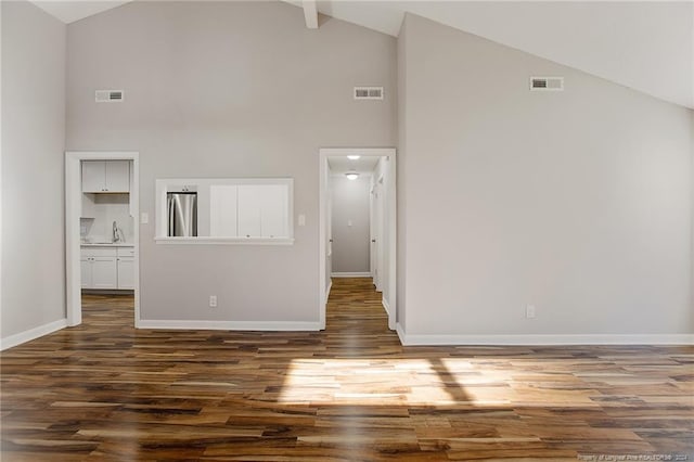 interior space featuring dark hardwood / wood-style flooring and high vaulted ceiling