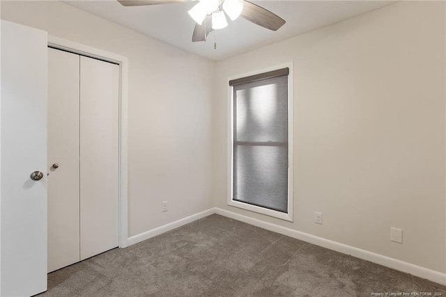 unfurnished bedroom with ceiling fan, a closet, and carpet floors