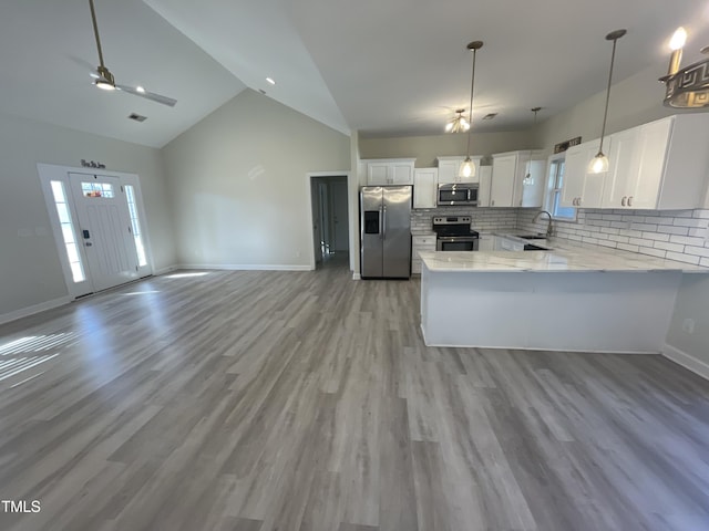 kitchen featuring sink, white cabinetry, stainless steel appliances, and light hardwood / wood-style flooring