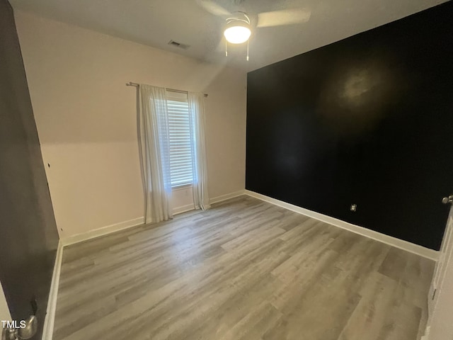 unfurnished room with ceiling fan and light hardwood / wood-style floors