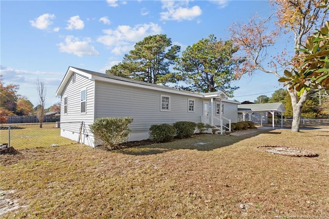 exterior space featuring a yard and a carport