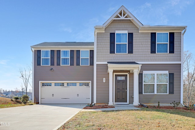 view of front of property featuring a front yard and a garage