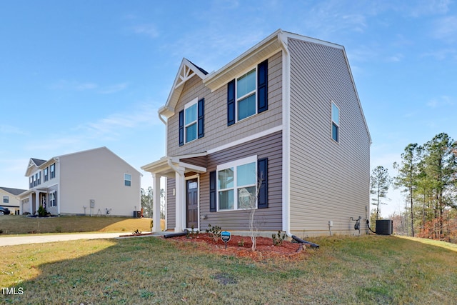 view of front of house featuring central AC and a front lawn