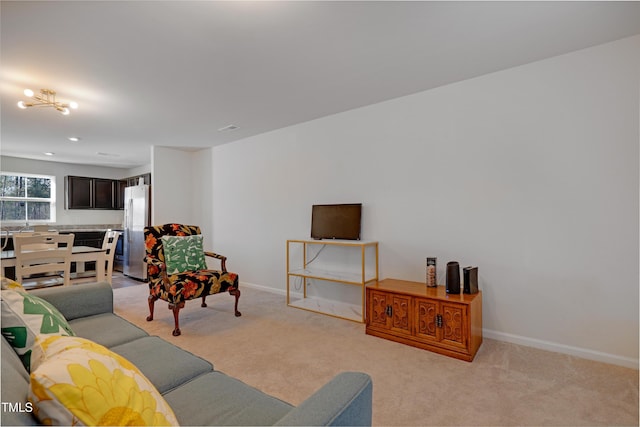 living room featuring light colored carpet and a chandelier