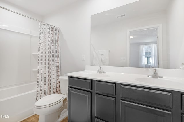 full bathroom with shower / bath combination with curtain, vanity, and toilet