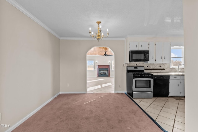 kitchen with backsplash, light colored carpet, crown molding, black appliances, and white cabinetry