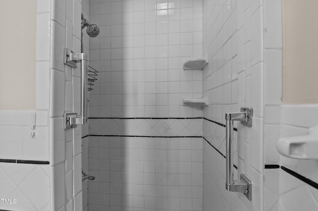 bathroom with a tile shower