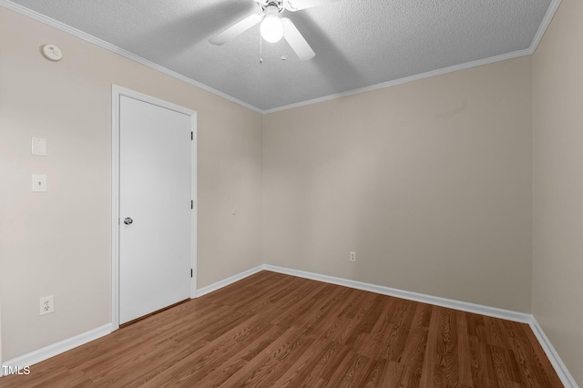 empty room with a textured ceiling, hardwood / wood-style flooring, ceiling fan, and ornamental molding