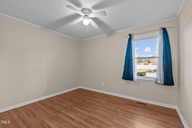 empty room featuring hardwood / wood-style floors, a textured ceiling, ceiling fan, and crown molding