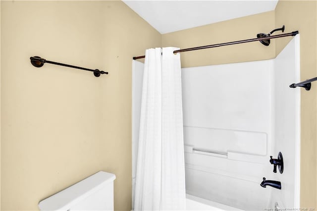 bathroom with toilet and shower / tub combo with curtain