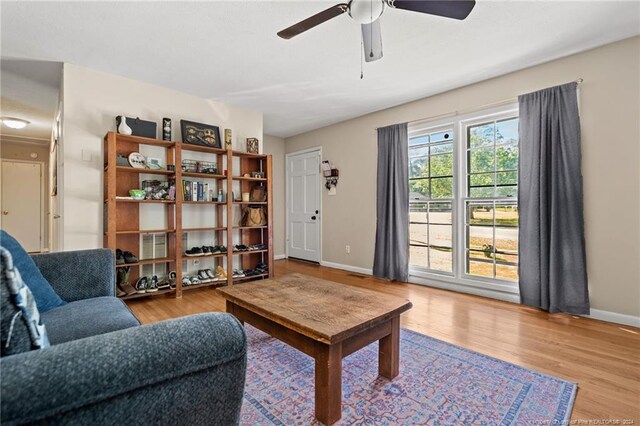 living room featuring light hardwood / wood-style flooring and ceiling fan