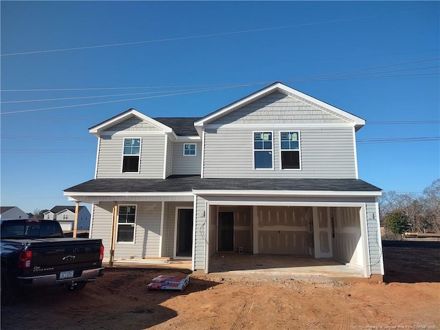 view of front of house featuring a porch and a garage