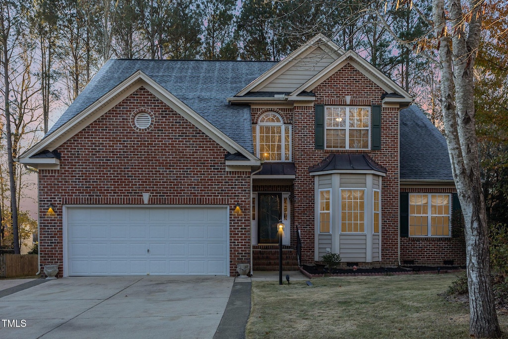 front of property featuring a garage and a front yard