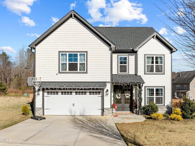 view of property featuring a garage and french doors