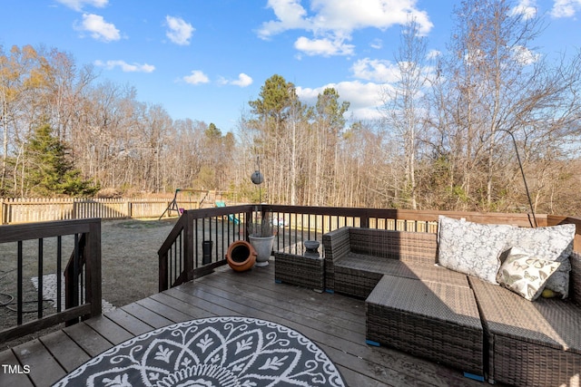 wooden deck with a playground and an outdoor living space