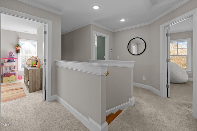 hall with light carpet, plenty of natural light, and ornamental molding