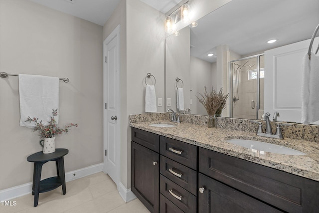 bathroom featuring tile patterned flooring, vanity, and an enclosed shower