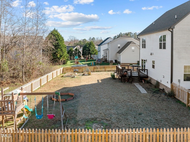 view of yard featuring a playground and a wooden deck