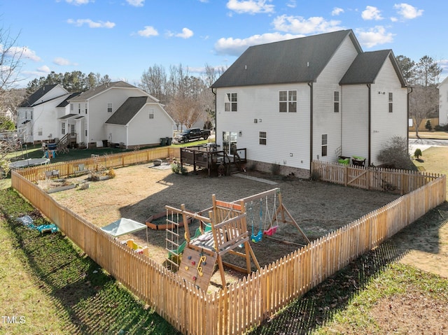 back of property with a playground