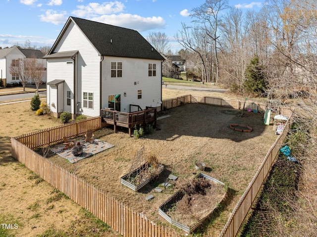 back of house with a deck