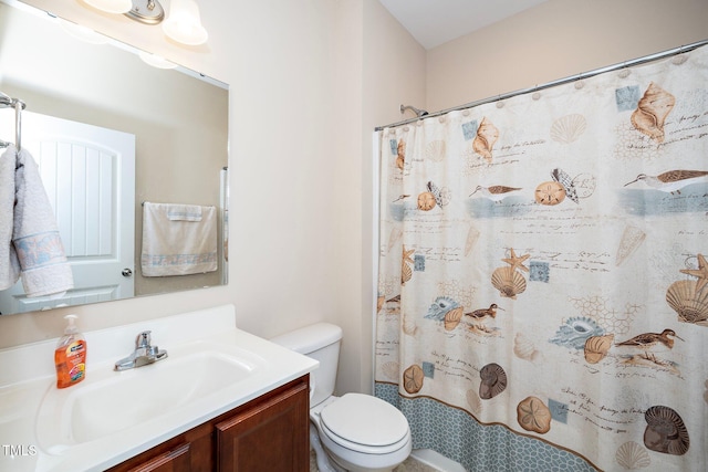 bathroom with vanity, curtained shower, and toilet