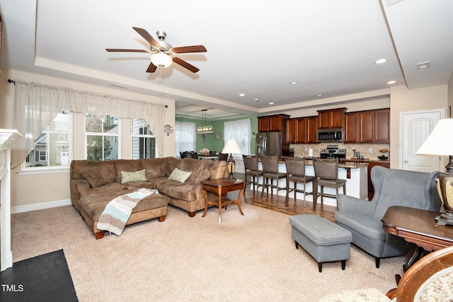 living room with ceiling fan and light carpet