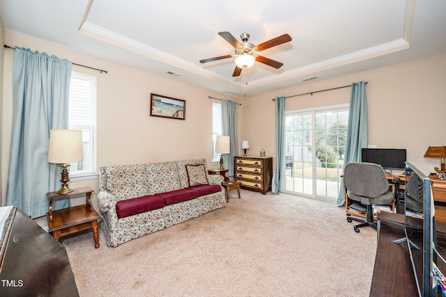 home office featuring carpet flooring, a tray ceiling, and ceiling fan