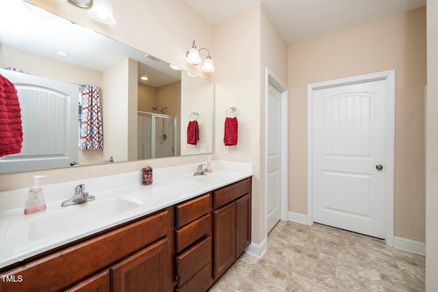 bathroom with vanity and a shower with shower door