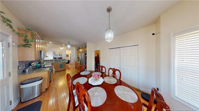 dining room featuring a chandelier and light hardwood / wood-style flooring