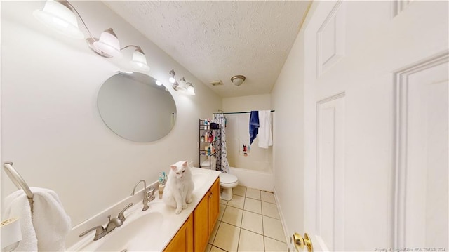 full bathroom with tile patterned floors, vanity, a textured ceiling, shower / bath combo with shower curtain, and toilet