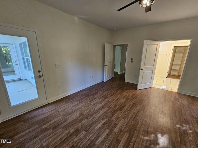 unfurnished bedroom featuring dark hardwood / wood-style floors and ceiling fan