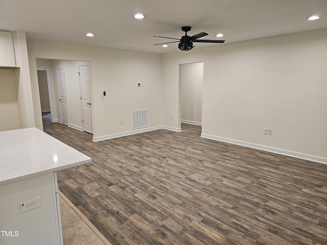 unfurnished living room featuring dark hardwood / wood-style floors and ceiling fan