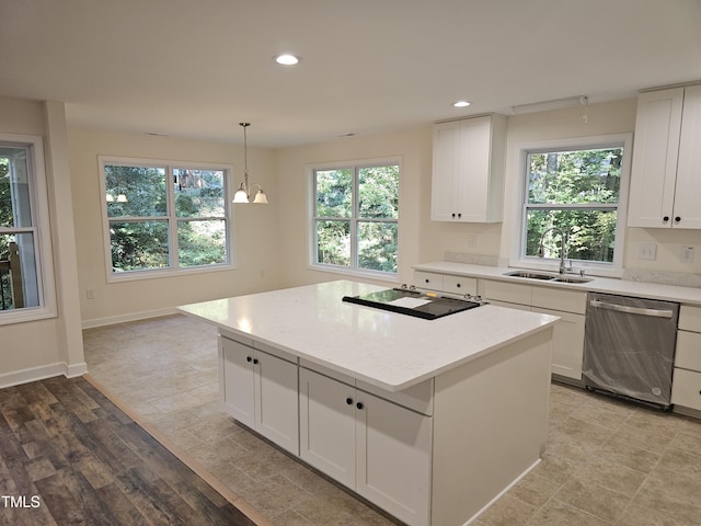 kitchen with white cabinets, sink, light hardwood / wood-style flooring, dishwasher, and a center island