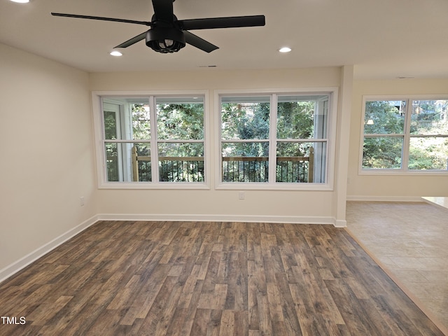 spare room with ceiling fan and dark wood-type flooring