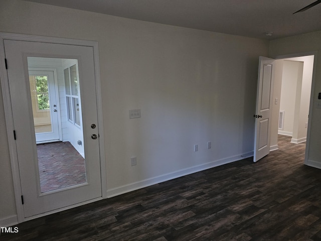 unfurnished room with dark hardwood / wood-style floors