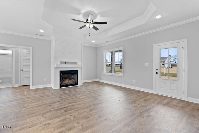 unfurnished living room with a fireplace, ceiling fan, light hardwood / wood-style flooring, and ornamental molding