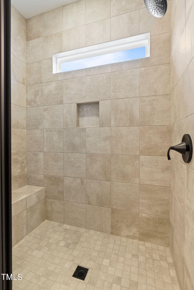 bathroom with a tile shower