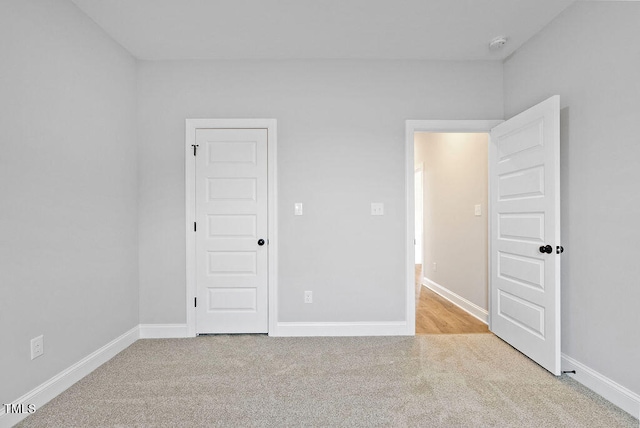 unfurnished bedroom with light colored carpet