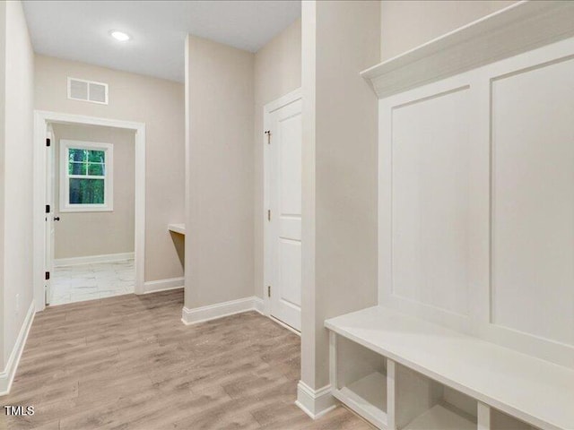 mudroom with light hardwood / wood-style flooring