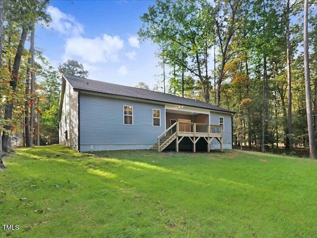 back of house with a lawn and a wooden deck