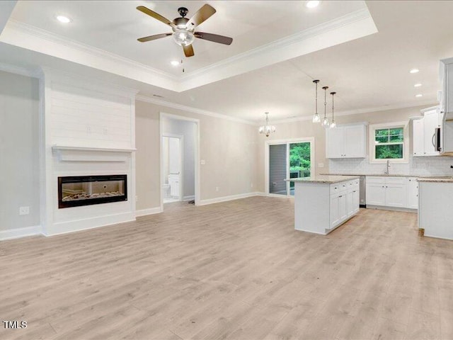 kitchen with a center island, light hardwood / wood-style flooring, white cabinetry, and hanging light fixtures