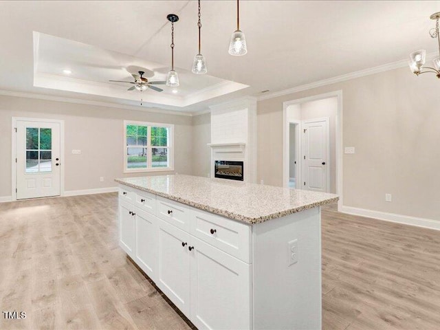 kitchen with plenty of natural light, white cabinetry, and hanging light fixtures